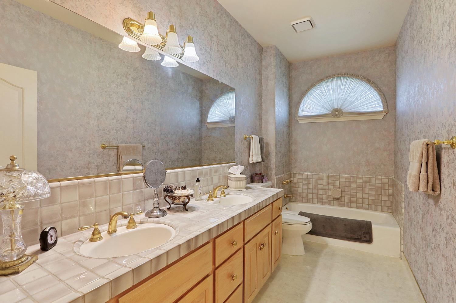 11791 Alpine Road Lodi, CA 95240 - Photo 40 of 74 a bathroom with a sink a toilet and a mirror