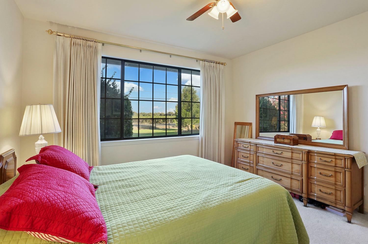 11791 Alpine Road Lodi, CA 95240 - Photo 42 of 74 a bedroom with a bed and a large window
