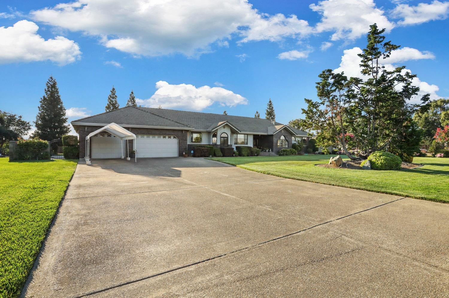 11791 Alpine Road Lodi, CA 95240 - Photo 5 of 74 a front view of a house with a yard and trees
