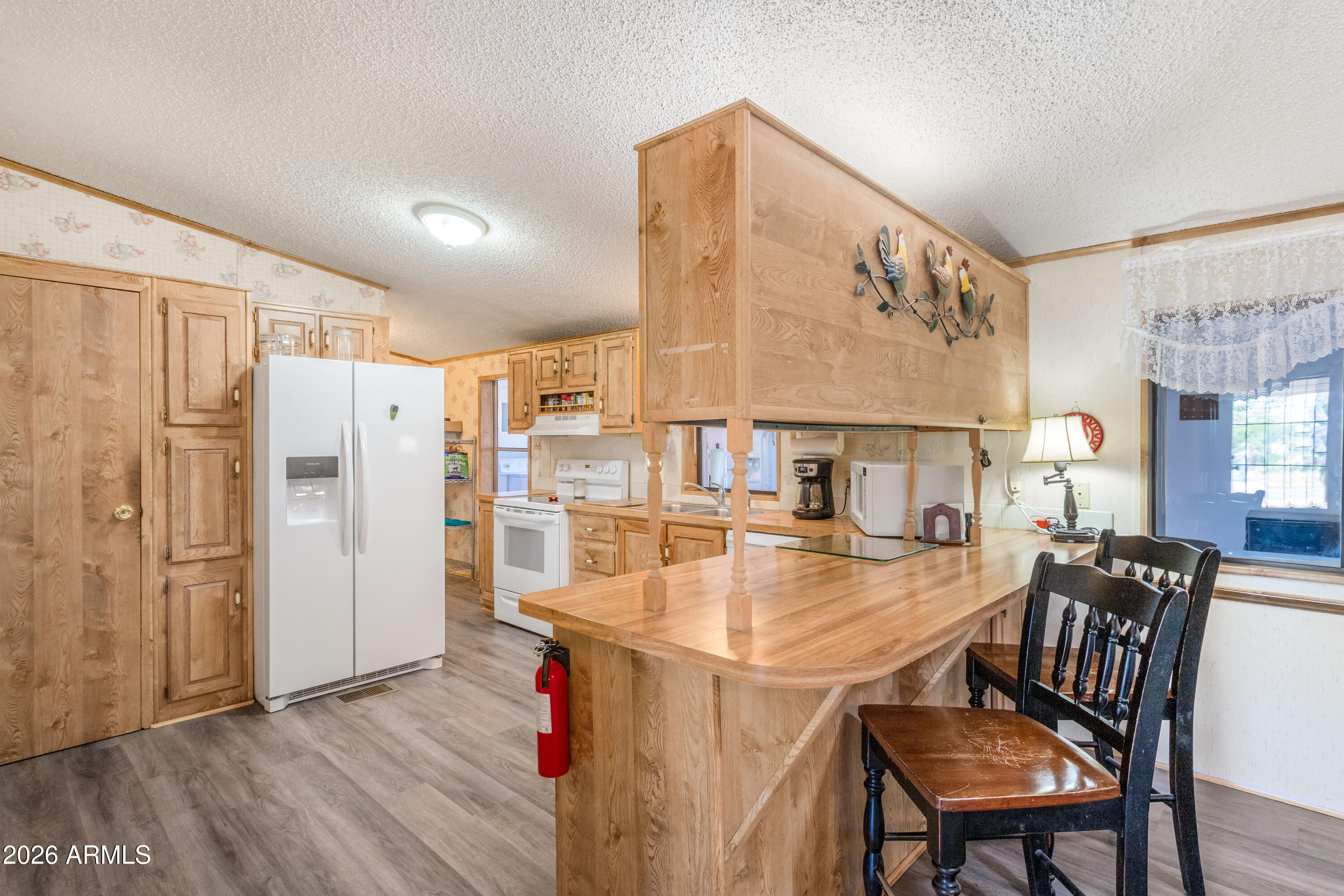 1935 North Tortoise Trail Dragoon, AZ 85609 - Photo 11 of 38 a dining hall with stainless steel appliances a dining table and chairs