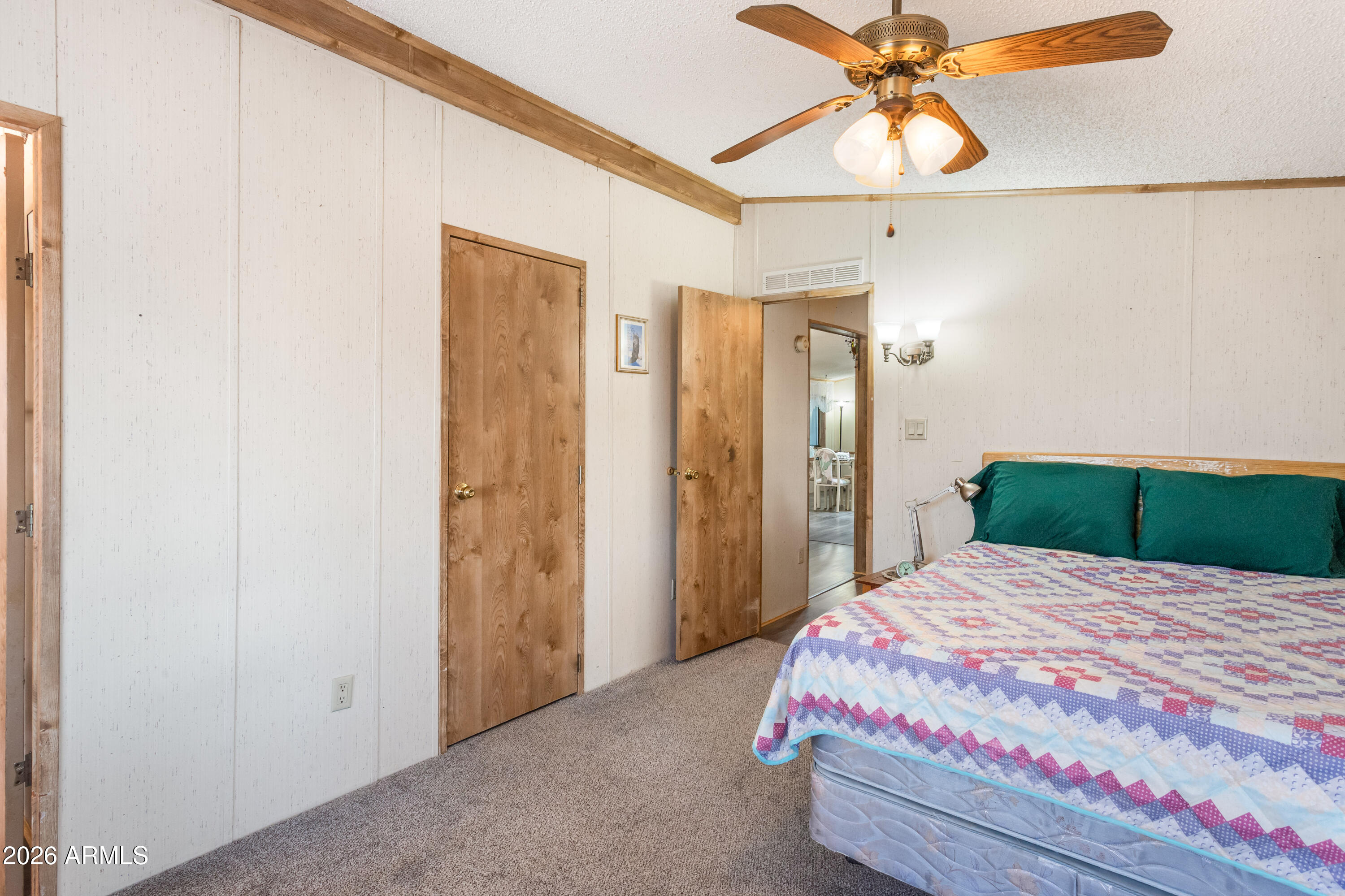 1935 North Tortoise Trail Dragoon, AZ 85609 - Photo 14 of 38 a bedroom with a bed and a chandelier