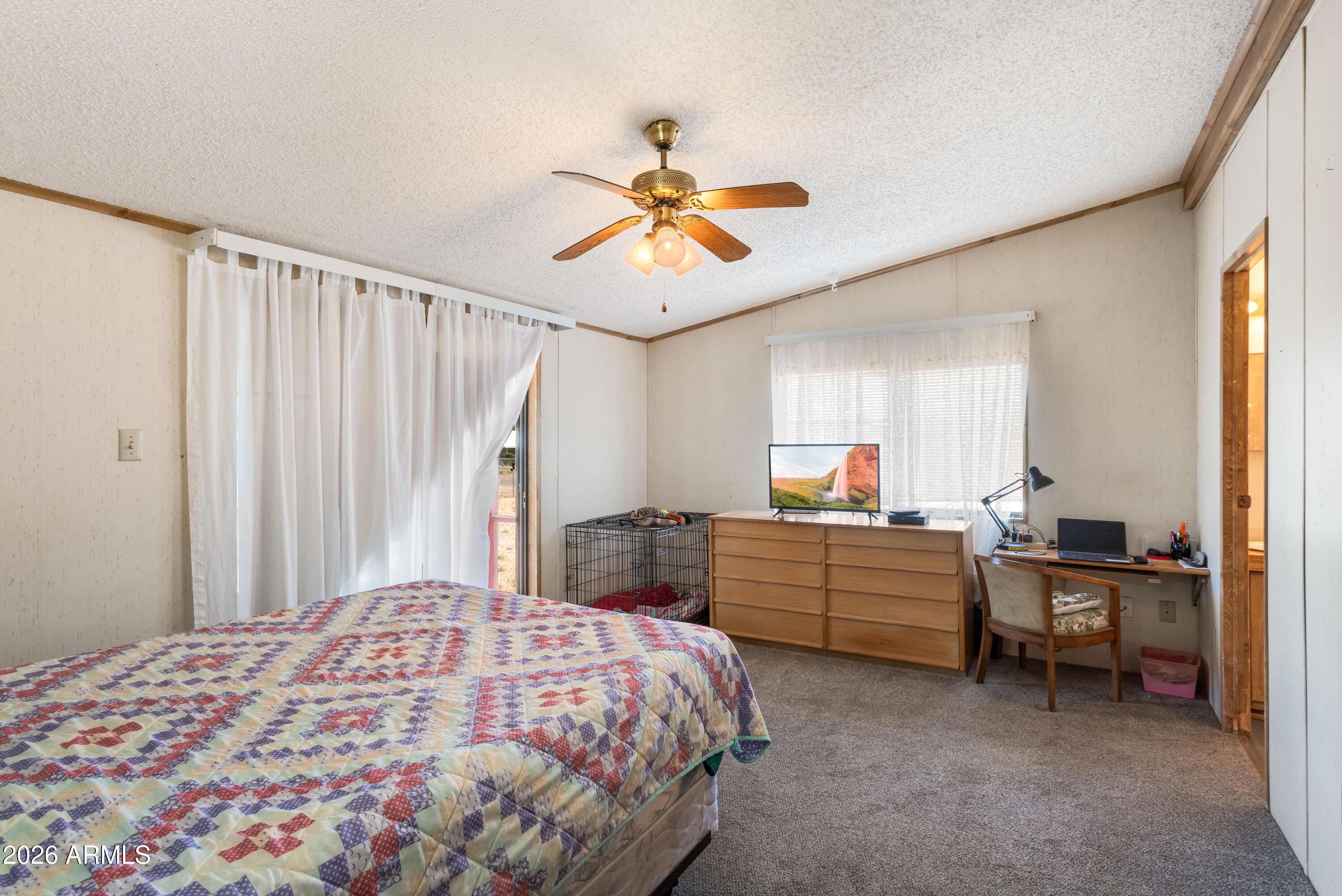 1935 North Tortoise Trail Dragoon, AZ 85609 - Photo 15 of 38 a bedroom with a bed and a chandelier fan