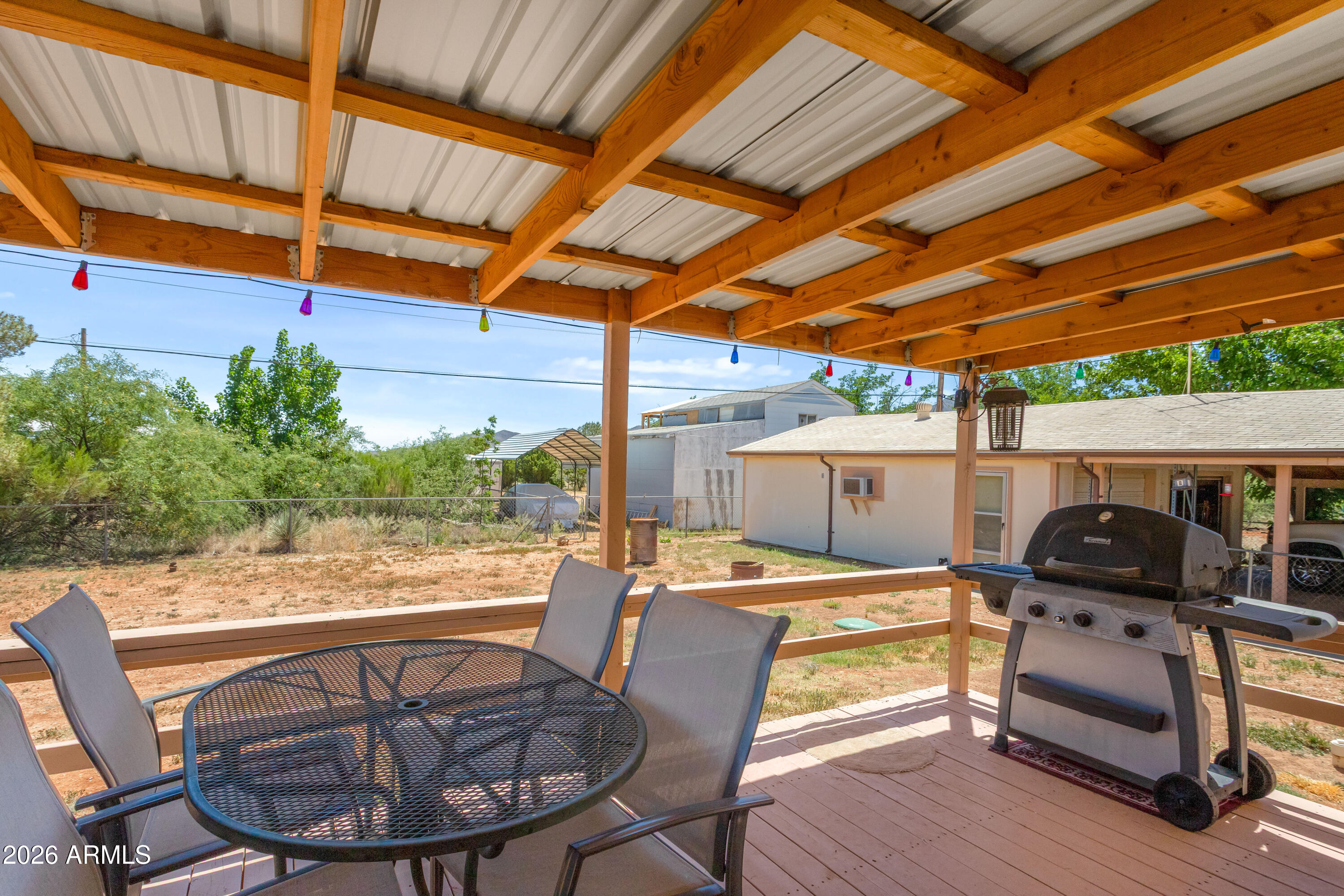 1935 North Tortoise Trail Dragoon, AZ 85609 - Photo 26 of 38 a view of a patio with table and chairs potted plants with wooden floor