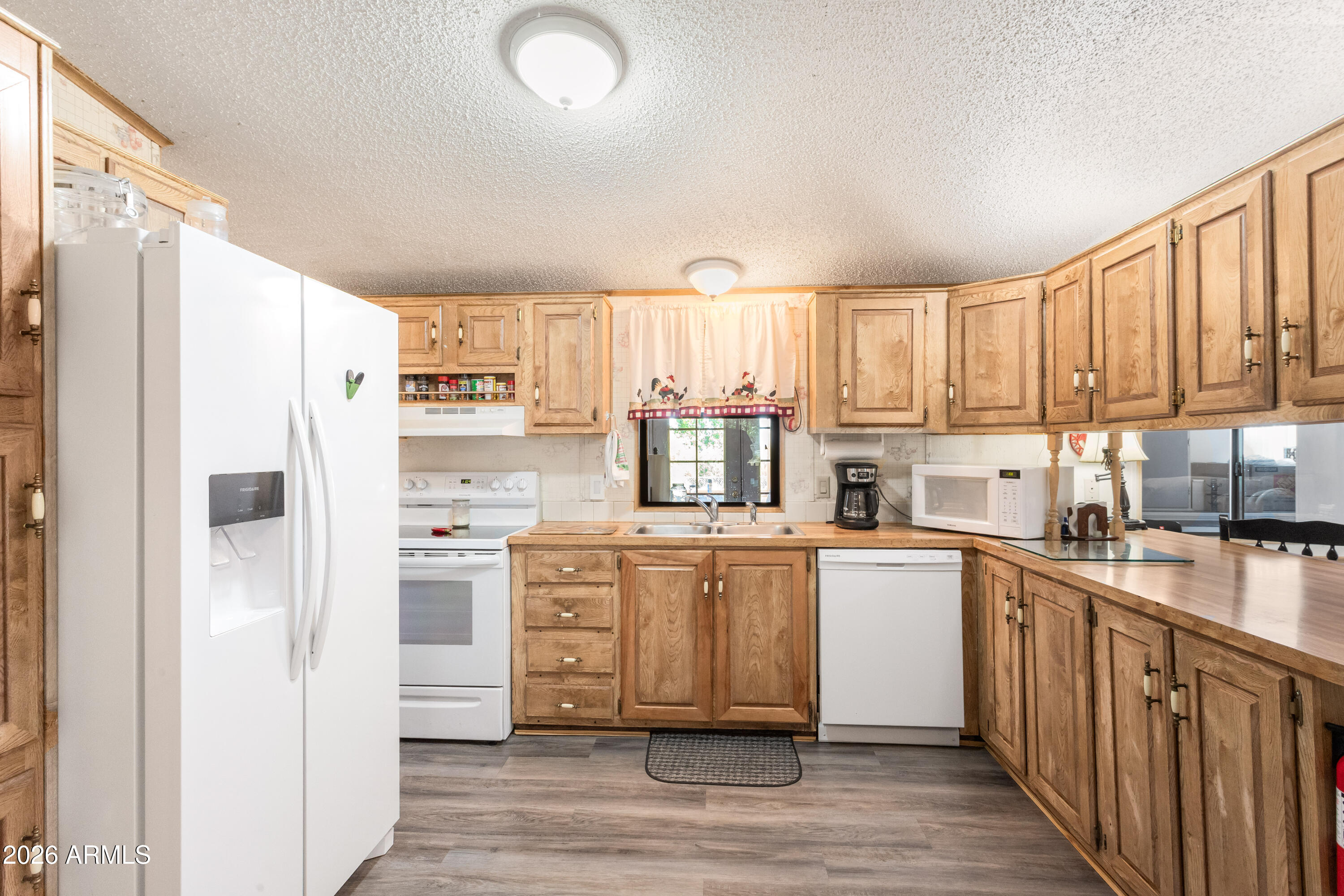 1935 North Tortoise Trail Dragoon, AZ 85609 - Photo 10 of 38 a kitchen with stainless steel appliances a refrigerator sink and cabinets