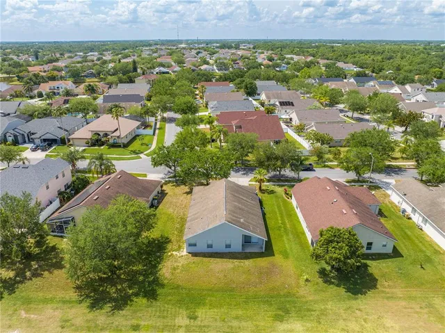 an aerial view of residential houses with outdoor space and swimming pool