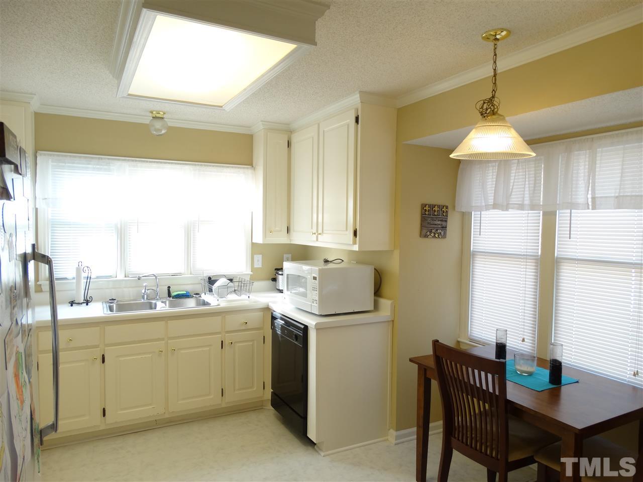 5000 Raleigh Road Benson, NC 27504 - Photo 11 of 25 a kitchen with a sink stove and cabinets