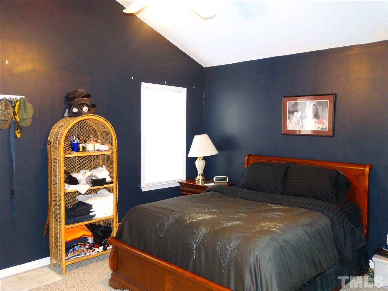 5000 Raleigh Road Benson, NC 27504 - Photo 13 of 25 a bedroom with a bed and a painting on the wall