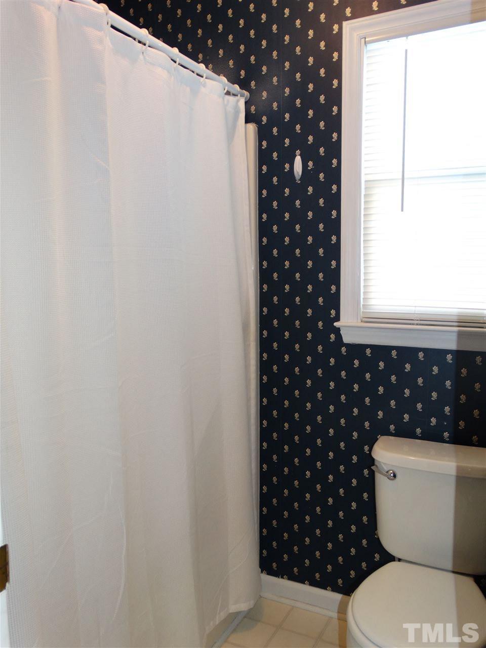 5000 Raleigh Road Benson, NC 27504 - Photo 16 of 25 a white toilet sitting next to a window