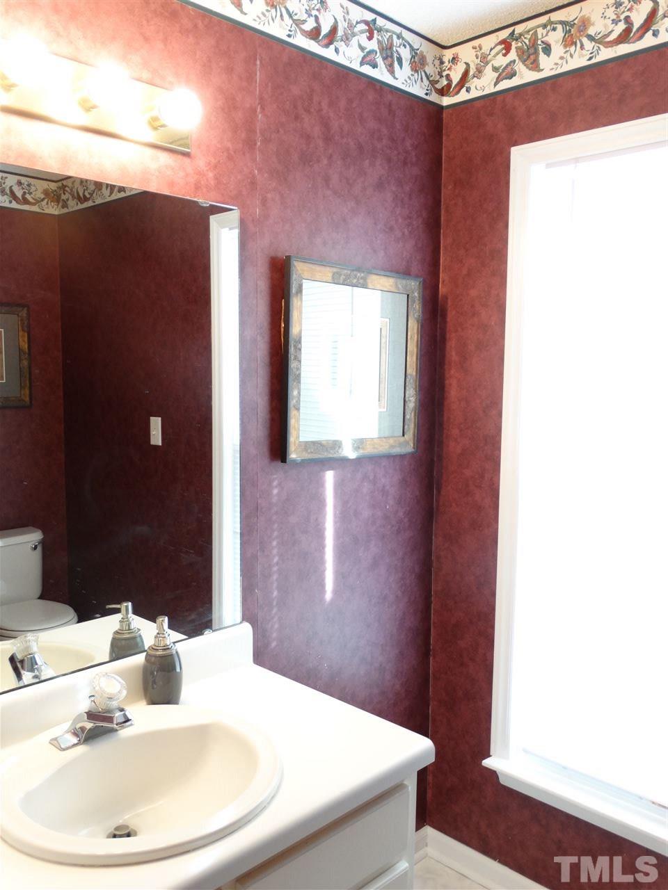 5000 Raleigh Road Benson, NC 27504 - Photo 19 of 25 a bathroom with a sink and a mirror