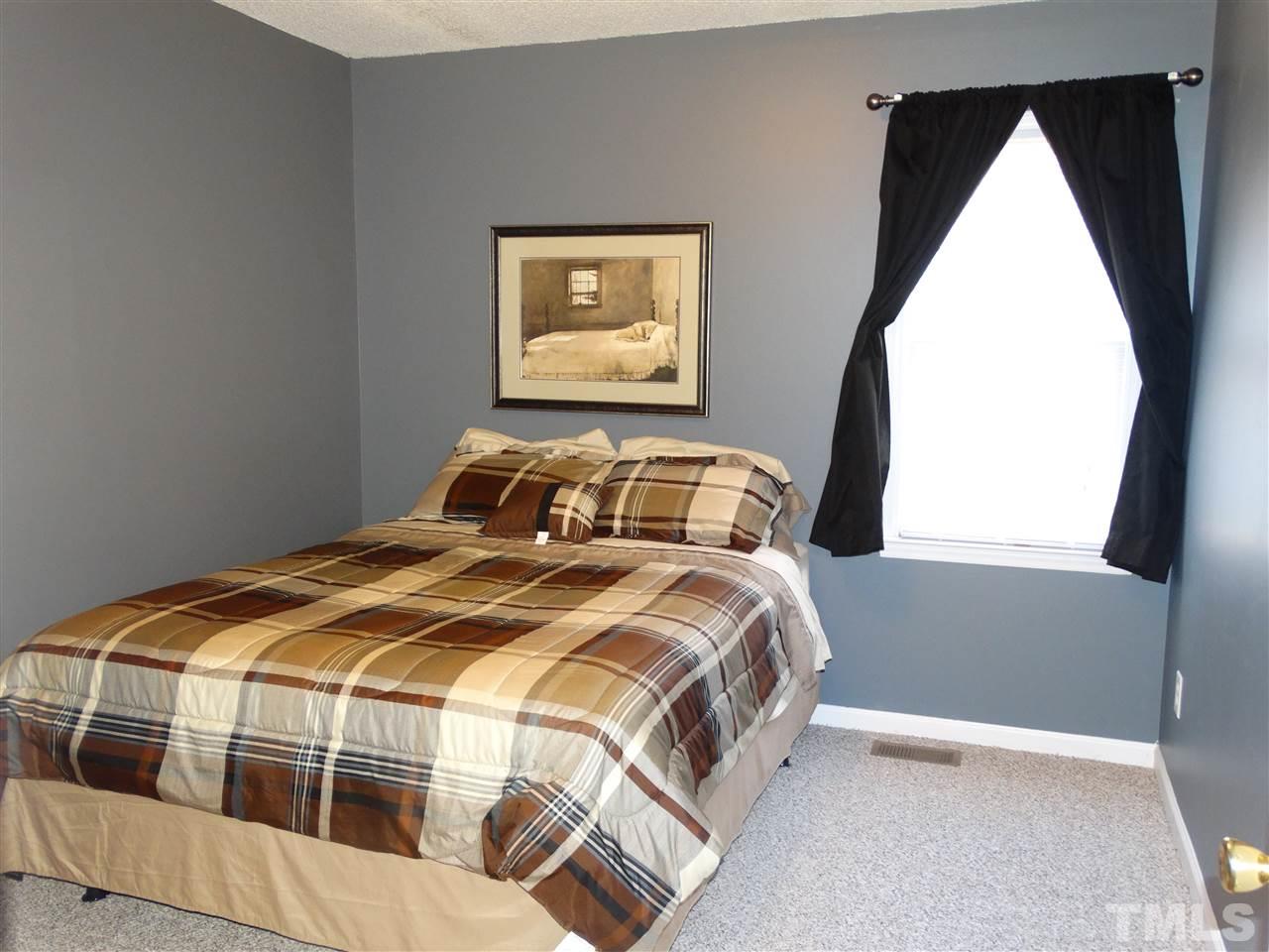 5000 Raleigh Road Benson, NC 27504 - Photo 20 of 25 a bedroom with a bed and a window