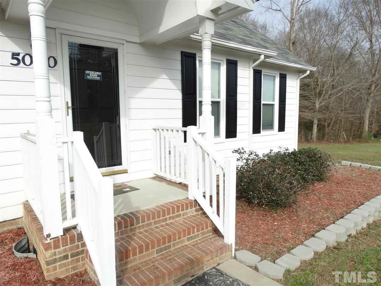 5000 Raleigh Road Benson, NC 27504 - Photo 5 of 25 front view of a house with a porch