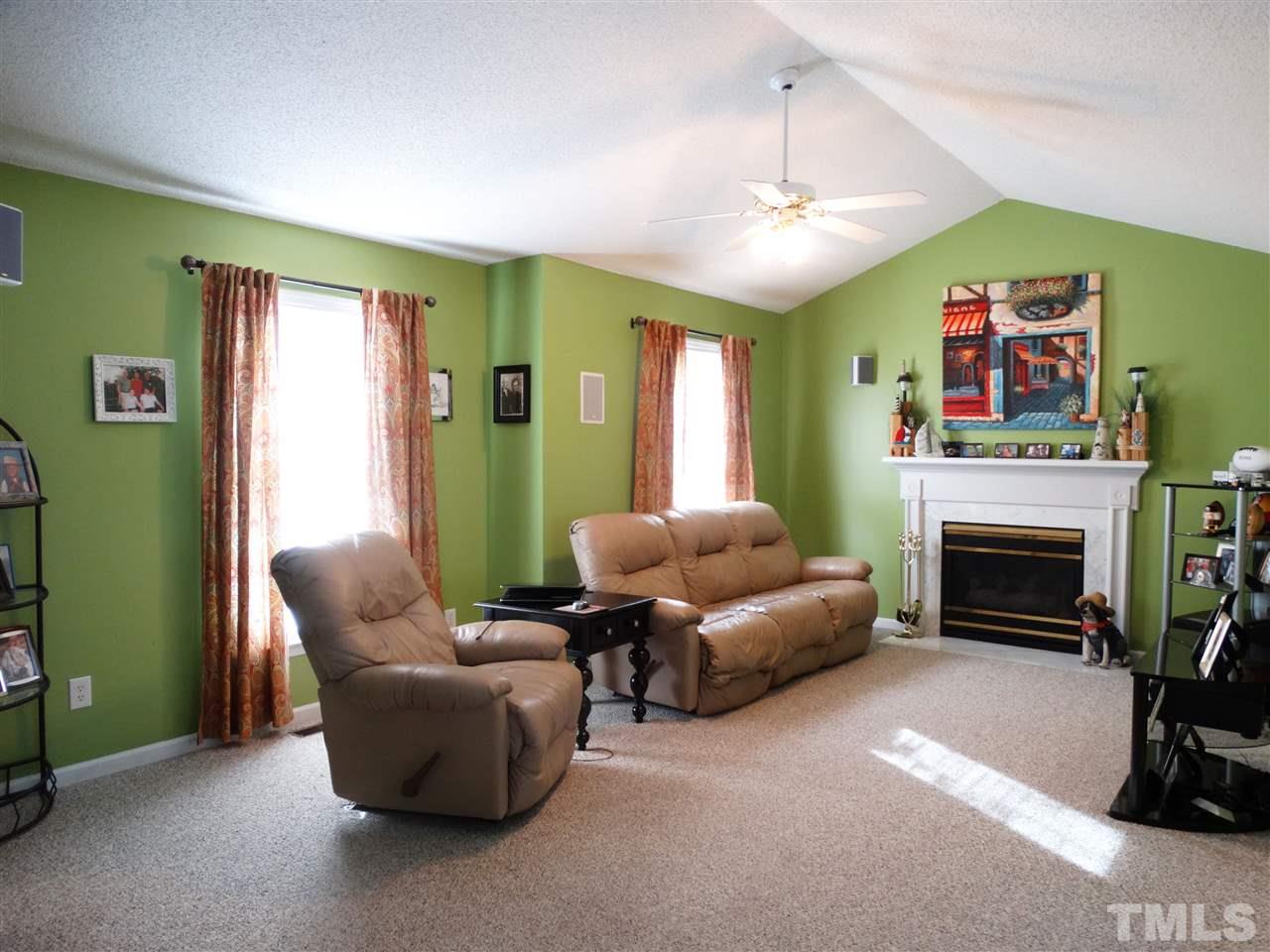 5000 Raleigh Road Benson, NC 27504 - Photo 7 of 25 a living room with furniture and a fireplace