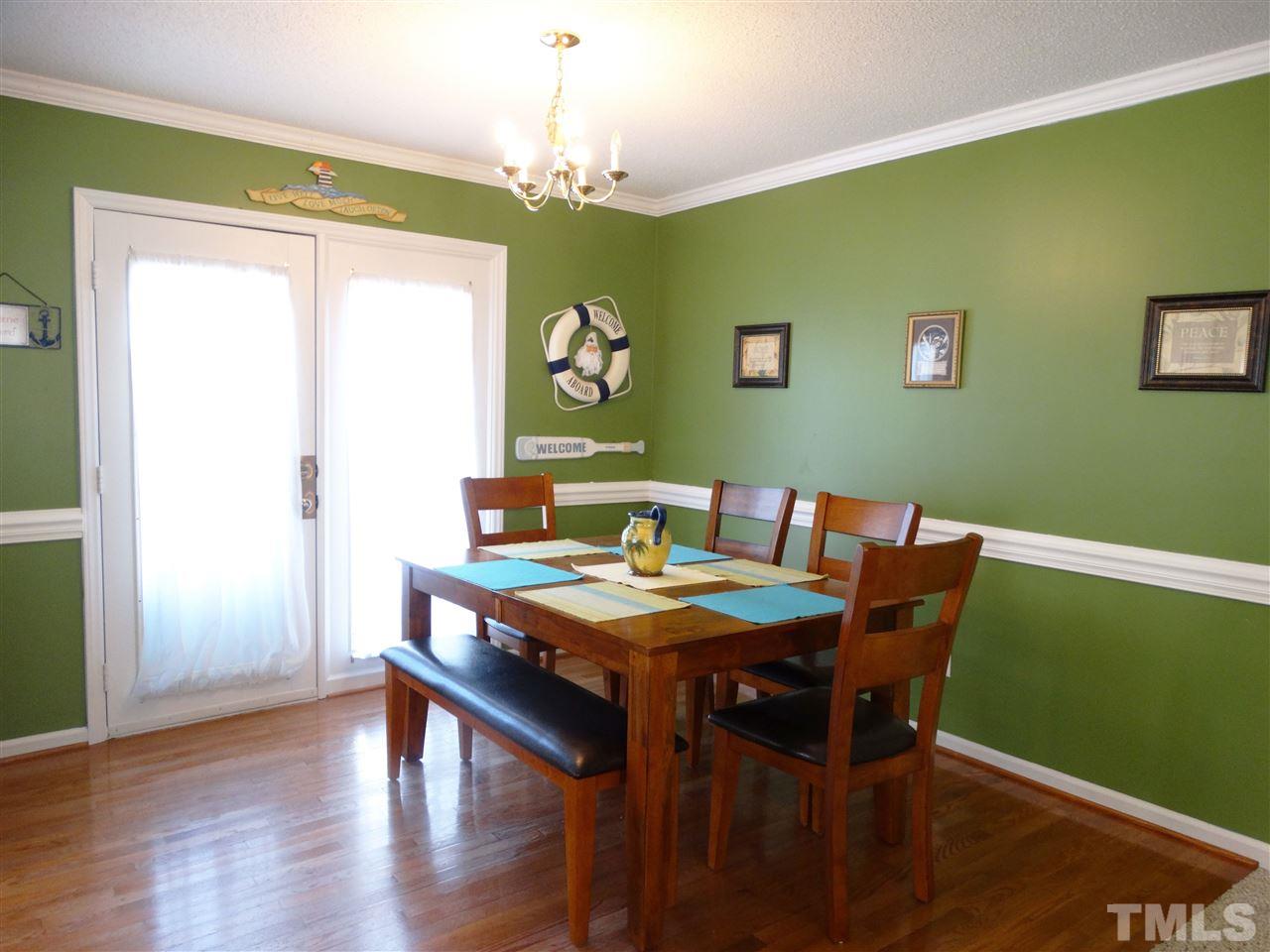 5000 Raleigh Road Benson, NC 27504 - Photo 9 of 25 a view of a dining room with furniture and wooden floor