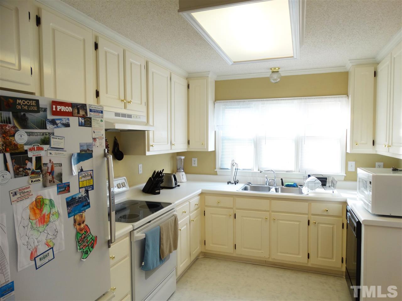 5000 Raleigh Road Benson, NC 27504 - Photo 10 of 25 a kitchen with white cabinets sink and white appliances