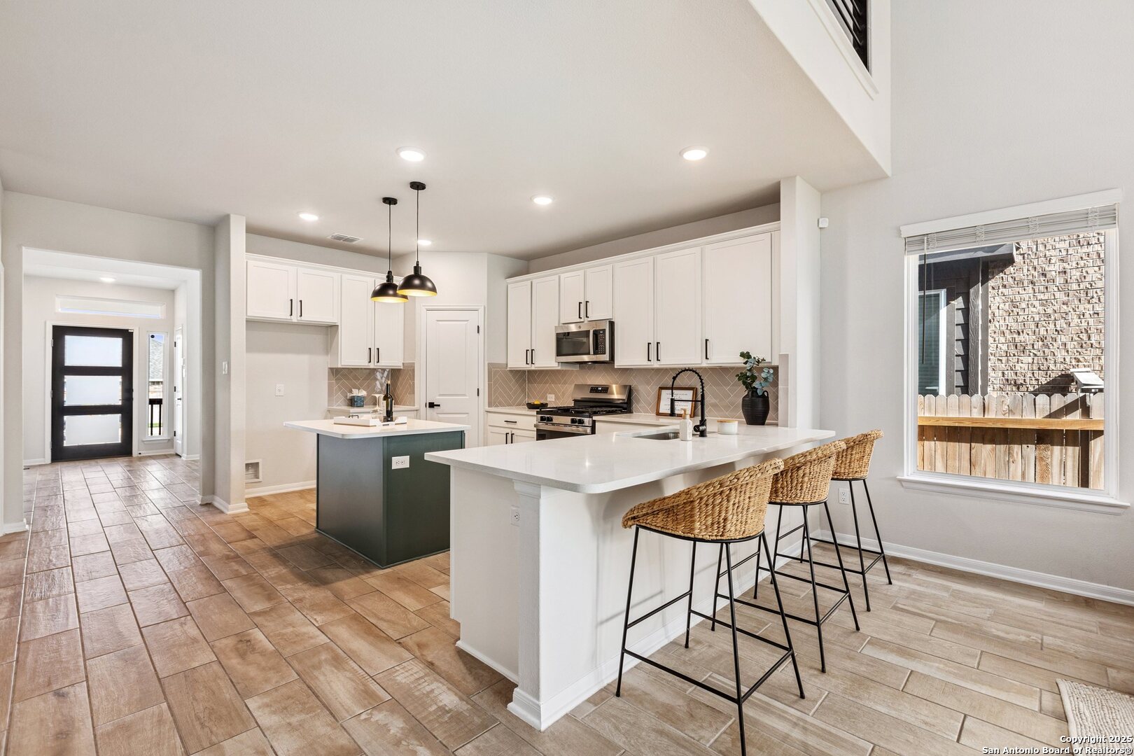 1707 Lawnside Road San Antonio, TX 78245 - Photo 13 of 64 a kitchen with stainless steel appliances kitchen island granite countertop a sink and cabinets