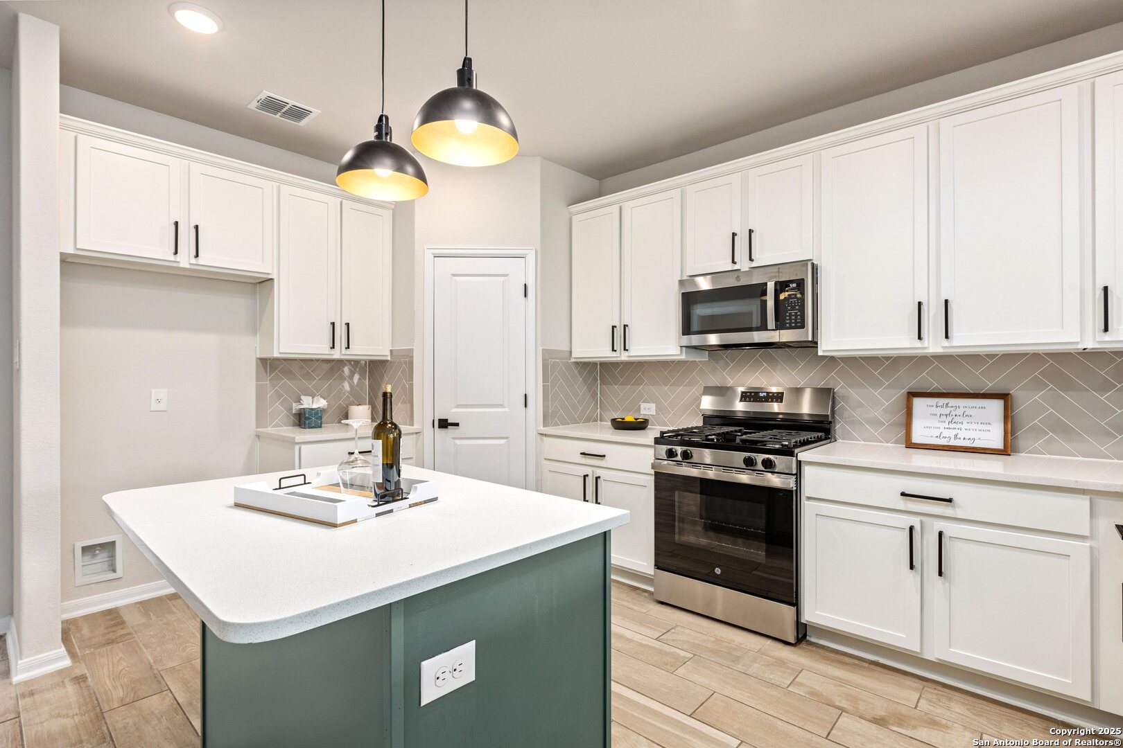 1707 Lawnside Road San Antonio, TX 78245 - Photo 20 of 64 a kitchen with stainless steel appliances a stove a sink and cabinets