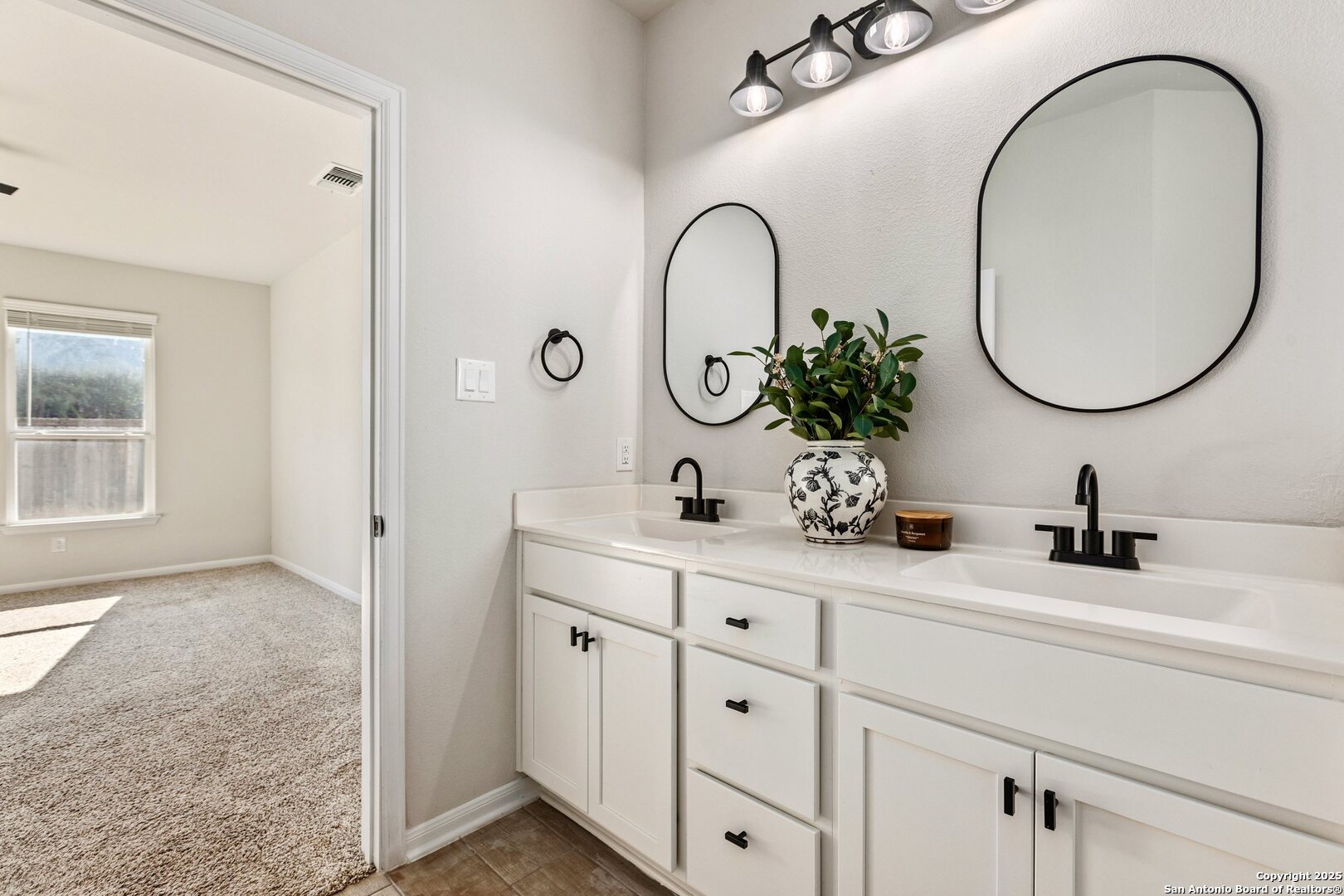 1707 Lawnside Road San Antonio, TX 78245 - Photo 26 of 64 a bathroom with a sink and a mirror