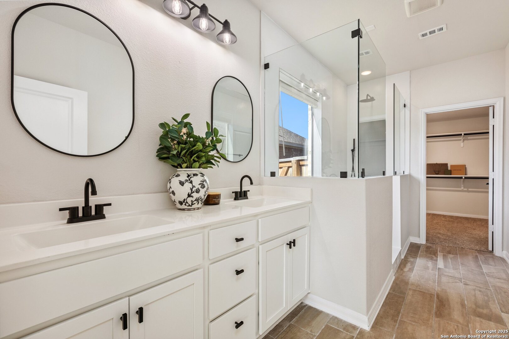 1707 Lawnside Road San Antonio, TX 78245 - Photo 3 of 64 a bathroom with a sink a mirror and a shower