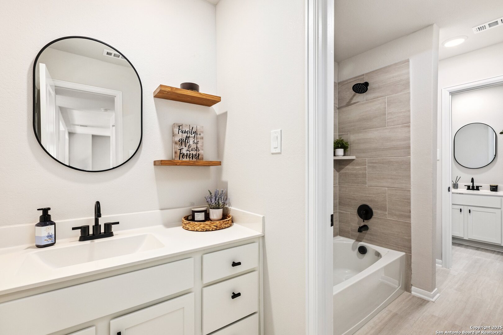 1707 Lawnside Road San Antonio, TX 78245 - Photo 33 of 64 a bathroom with a granite countertop sink mirror and bathtub