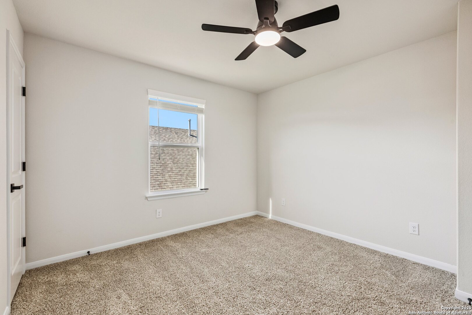 1707 Lawnside Road San Antonio, TX 78245 - Photo 47 of 64 an empty room with a window and a fan