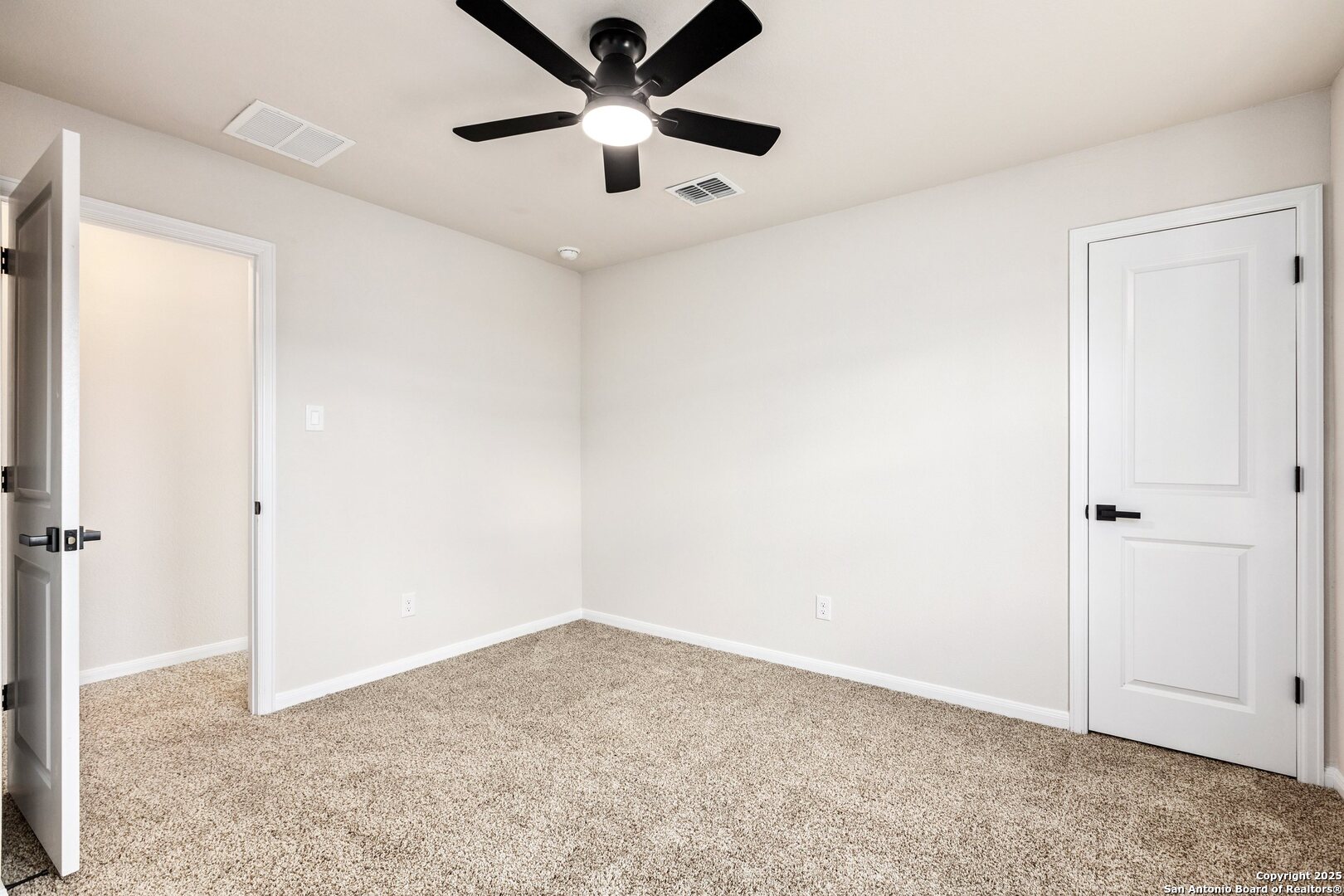 1707 Lawnside Road San Antonio, TX 78245 - Photo 49 of 64 an empty room with a ceiling fan and carpet