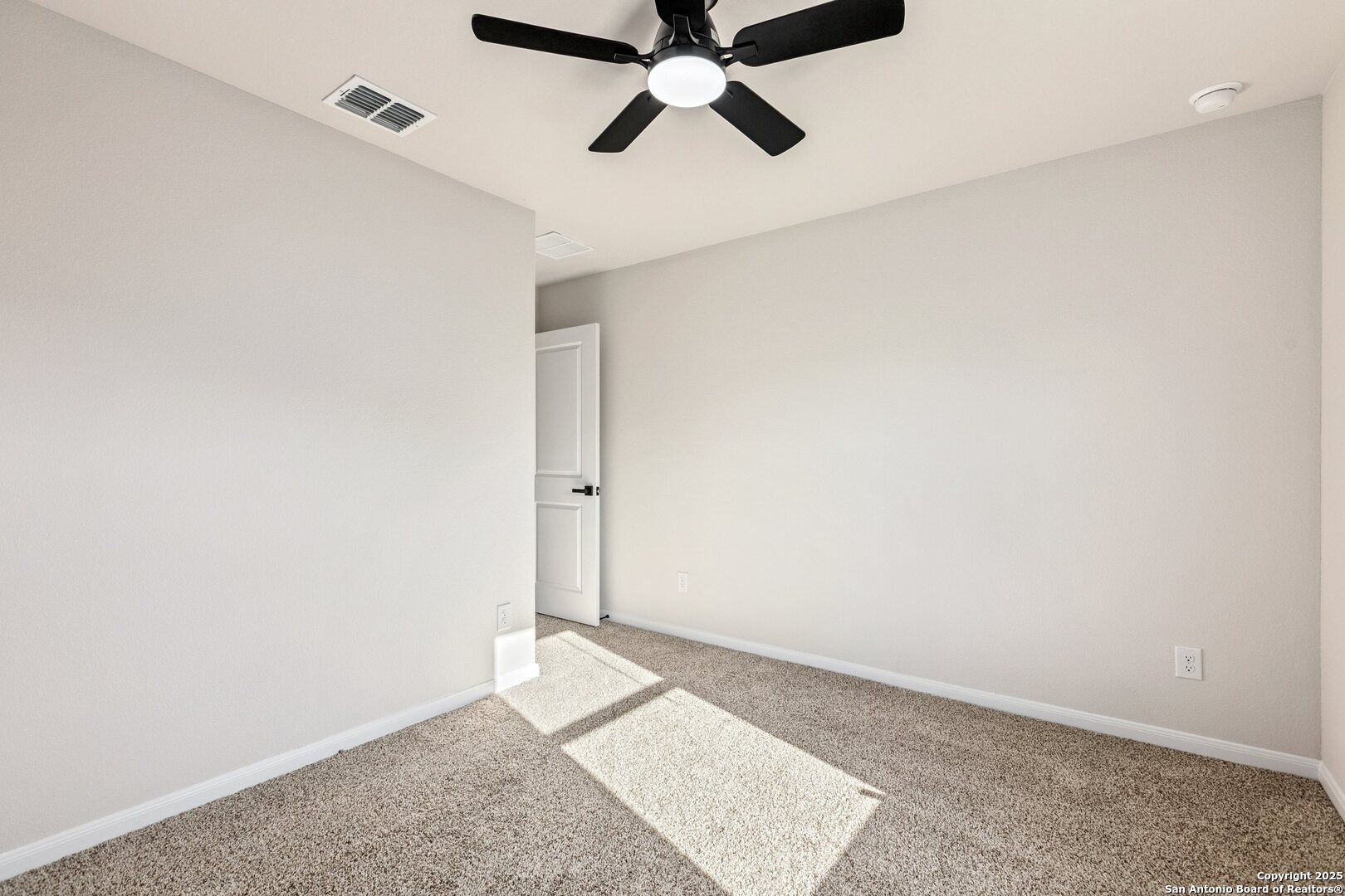 1707 Lawnside Road San Antonio, TX 78245 - Photo 52 of 64 an empty room with a ceiling fan and carpet