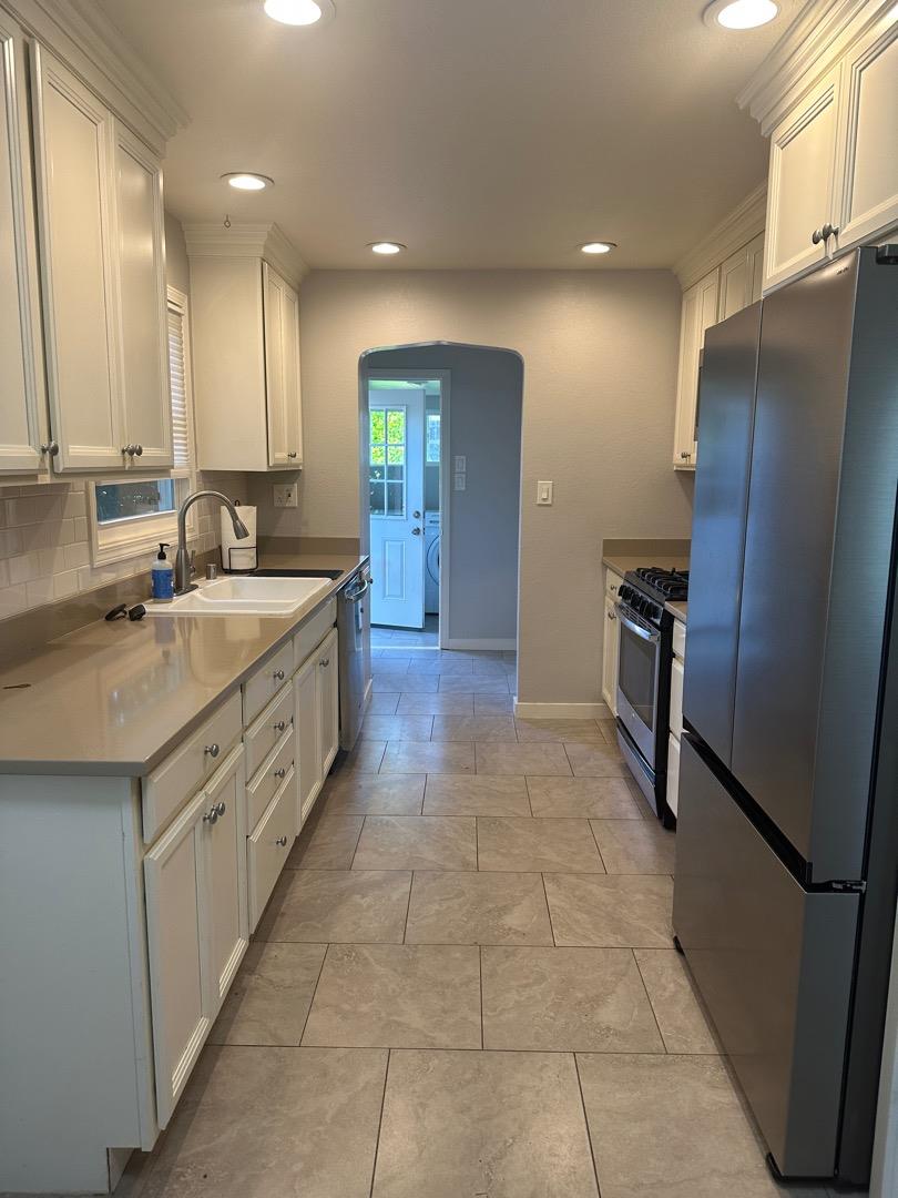 2061 Monticello Road Napa, CA 94558 - Photo 2 of 14 a large kitchen with a sink stainless steel appliances and cabinets