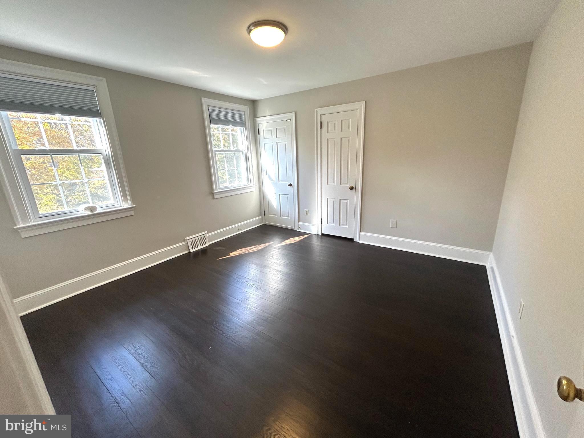 248 Hilldale Road Villanova, PA 19085 - Photo 13 of 21 an empty room with wooden floor and windows