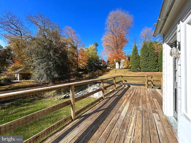 a view of balcony with wooden floor and fence