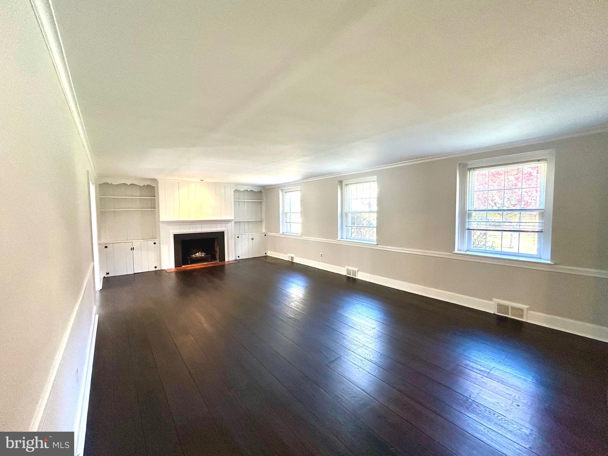 248 Hilldale Road Villanova, PA 19085 - Photo 9 of 21 an empty room with wooden floor and fireplace