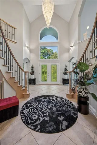 a view of a dining room with furniture a chandelier and wooden floor
