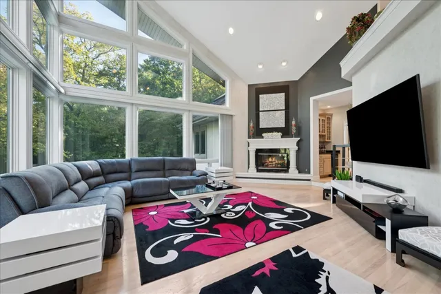 a living room with furniture and large windows