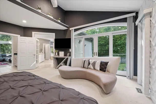 a living room with furniture a wooden floor and next to a window
