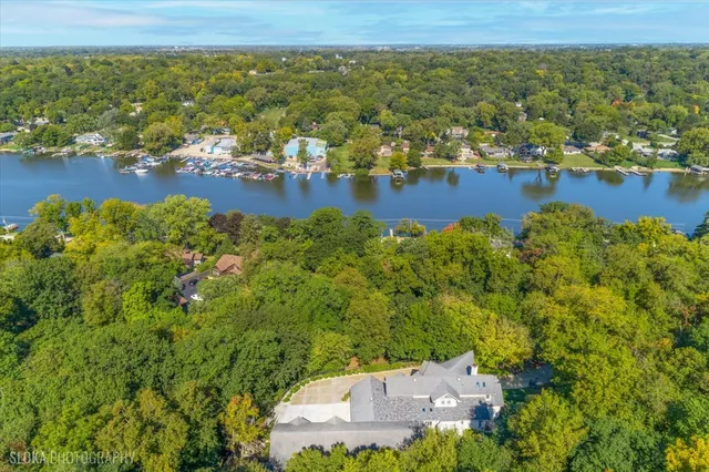 an aerial view of a house with a lake view