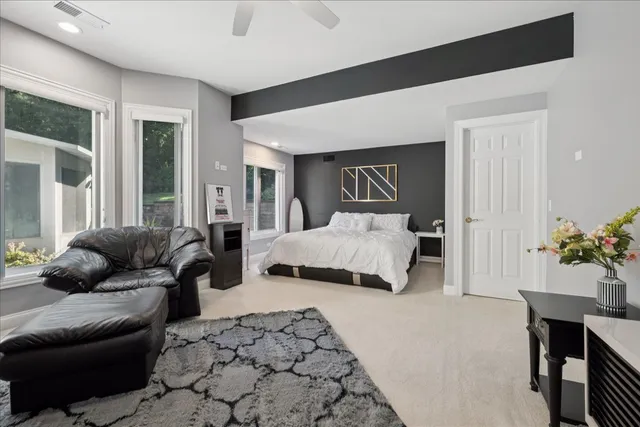 a living room with furniture a wooden floor and next to a window