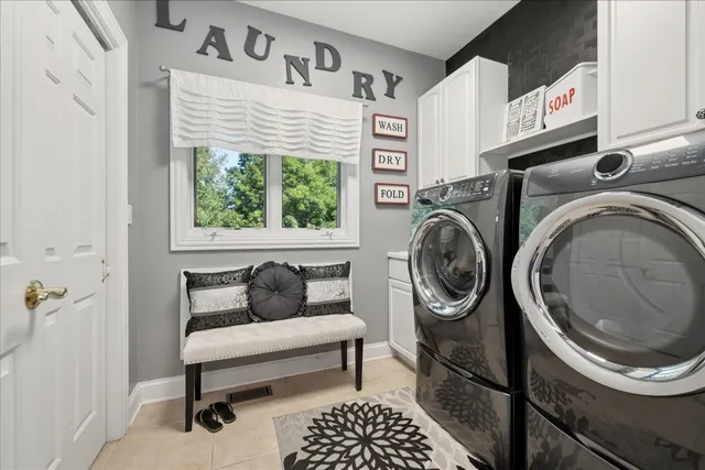 a living room with furniture a fireplace and a window