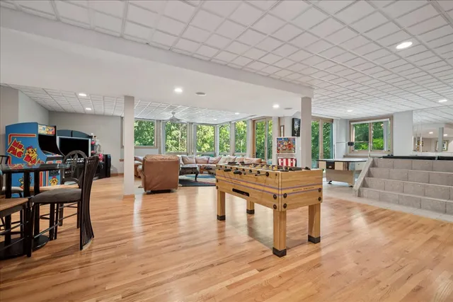 an aerial view of a house with a yard and green space