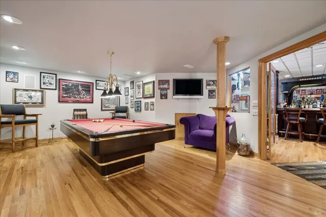 an aerial view of a house with swimming pool a yard and lake view