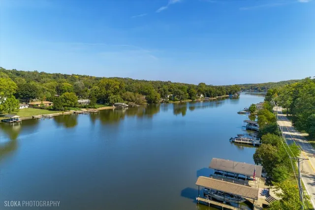 a view of a house with a small yard and wooden fence