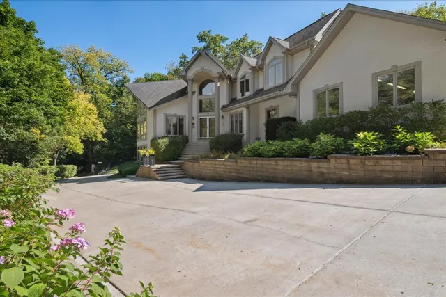 a living room with furniture a rug wooden floor and a large window
