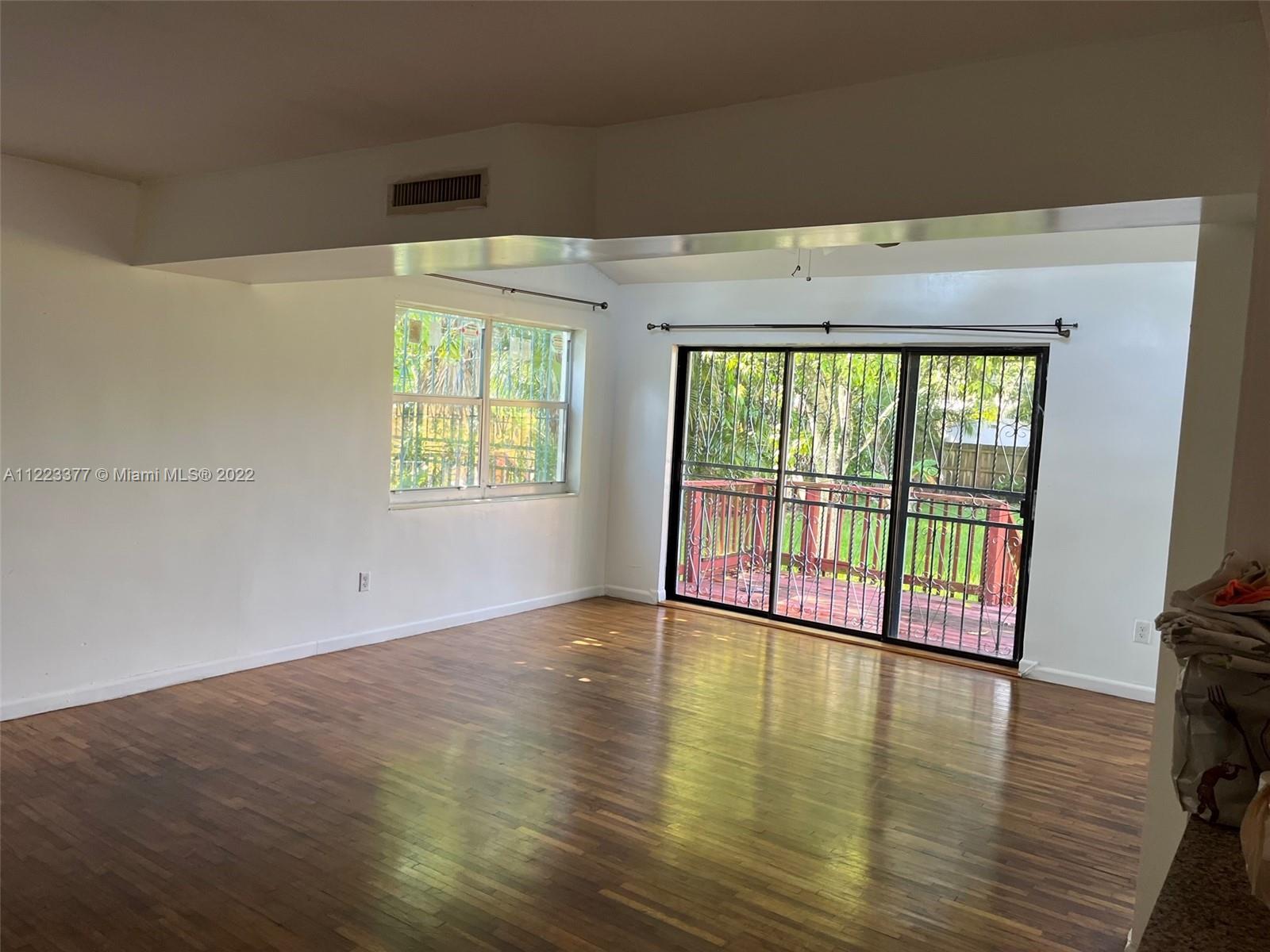 Miami-Dade County Miami, FL 33161 - Photo 2 of 10 a view of an empty room with wooden floor and a window