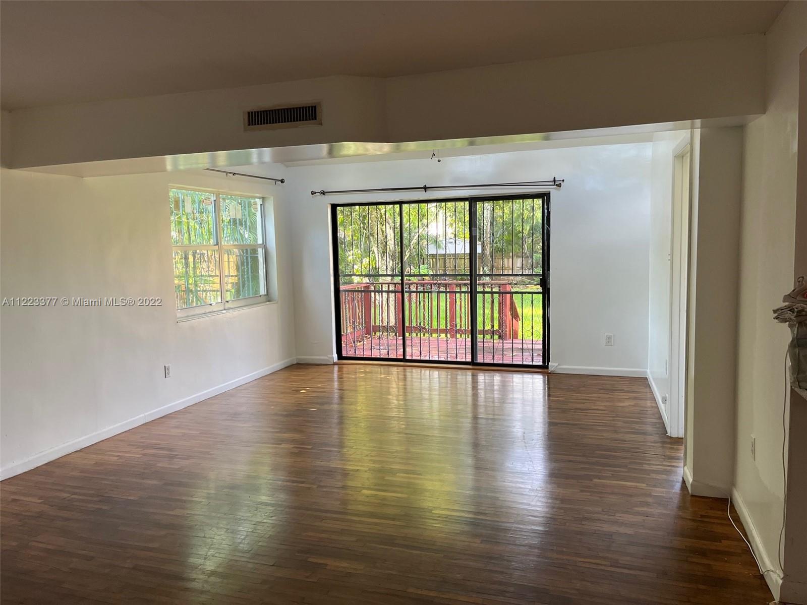 Miami-Dade County Miami, FL 33161 - Photo 3 of 10 a view of an empty room with wooden floor and a window