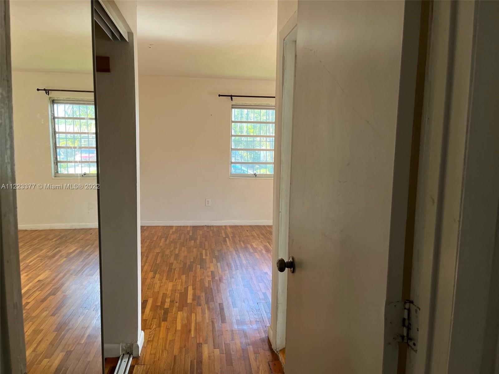 Miami-Dade County Miami, FL 33161 - Photo 4 of 10 a view of empty room with wooden floor and fan