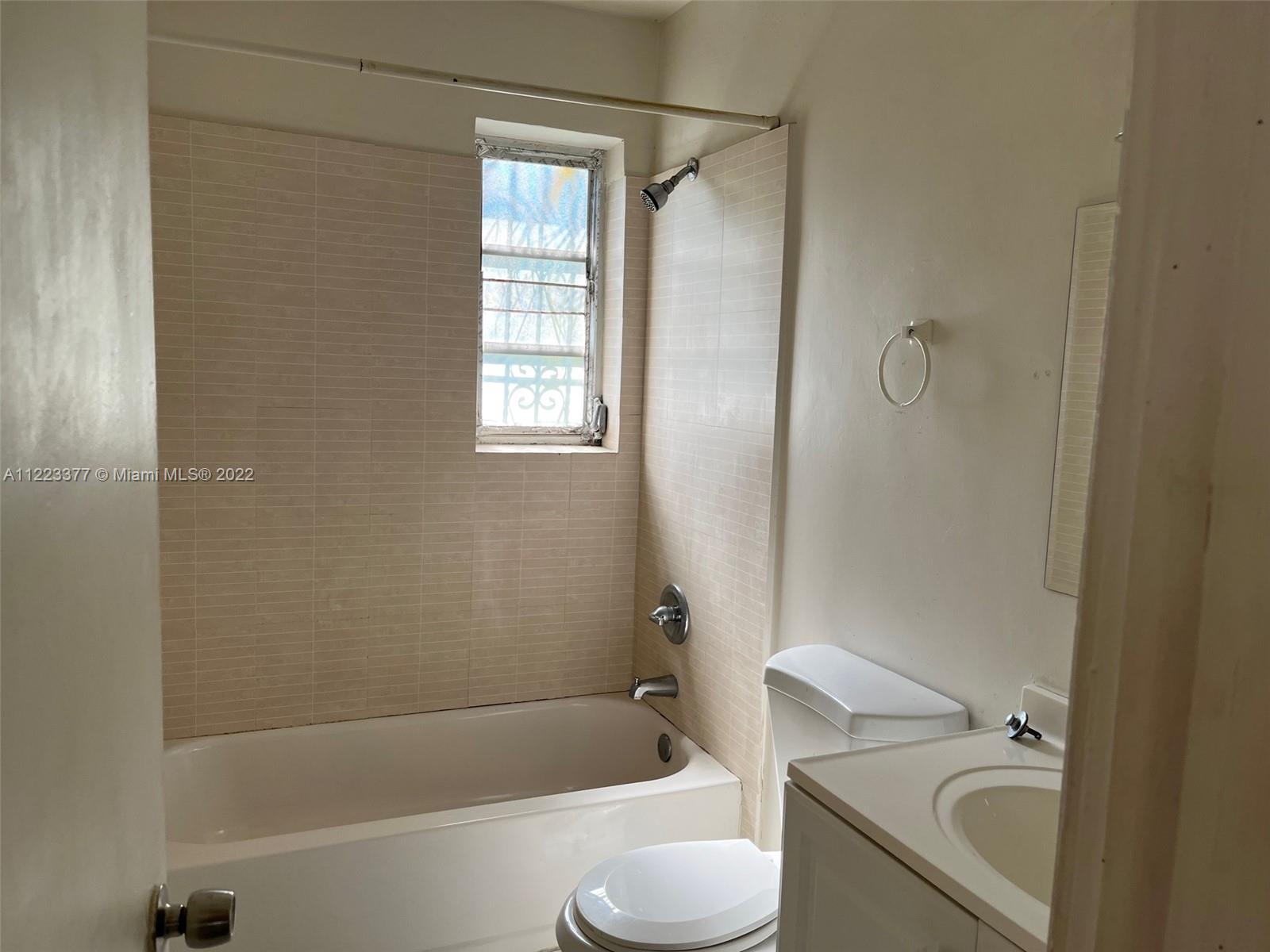 Miami-Dade County Miami, FL 33161 - Photo 6 of 10 a bathroom with a sink toilet and bathtub