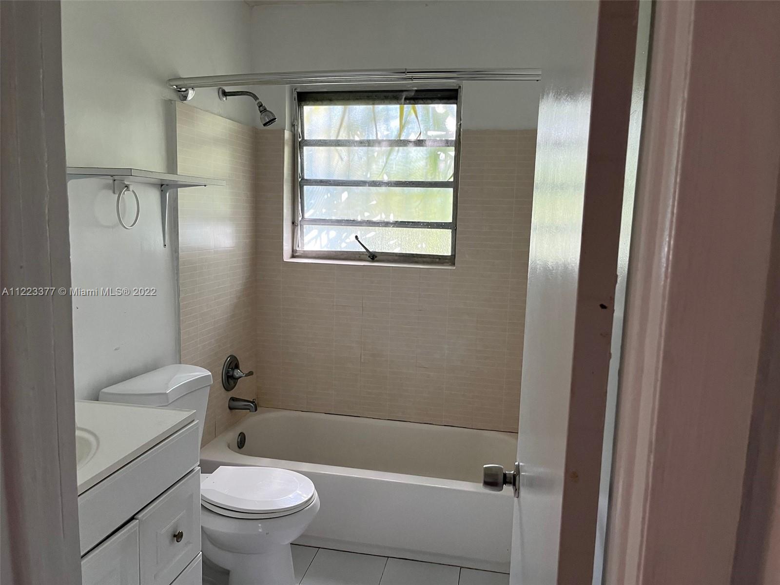 Miami-Dade County Miami, FL 33161 - Photo 8 of 10 a bathroom with a sink a toilet and shower