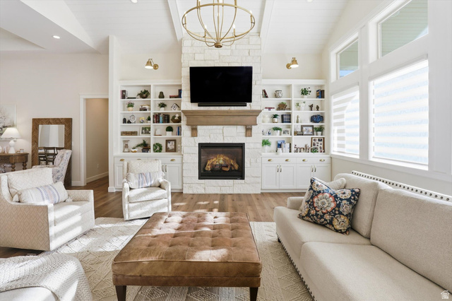 534 East Fish Hatchery Road Mantua, UT 84324 - Photo 6 of 87 Living area featuring suspended lighting, a fireplace, vaulted ceiling, and wood finished floors