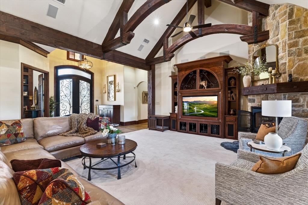 1625 Timber Ridge Trail Cross Roads, TX 76227 - Photo 13 of 40 Living area featuring high vaulted ceiling, a fireplace, beamed ceiling, and arched walkways