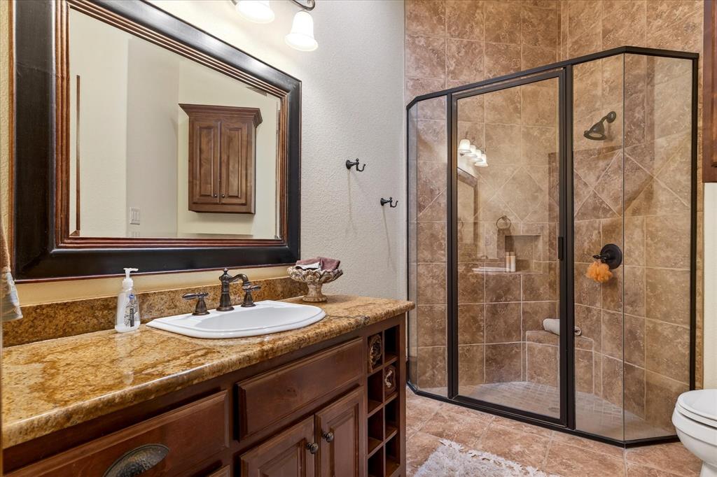 1625 Timber Ridge Trail Cross Roads, TX 76227 - Photo 18 of 40 Bathroom featuring vanity, a stall shower, and a textured wall