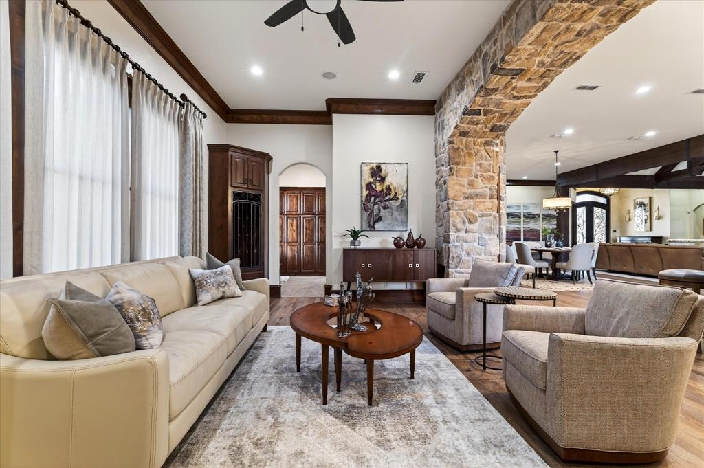 1625 Timber Ridge Trail Cross Roads, TX 76227 - Photo 25 of 40 Living room with arched walkways, crown molding, recessed lighting, ceiling fan, and light wood-type flooring
