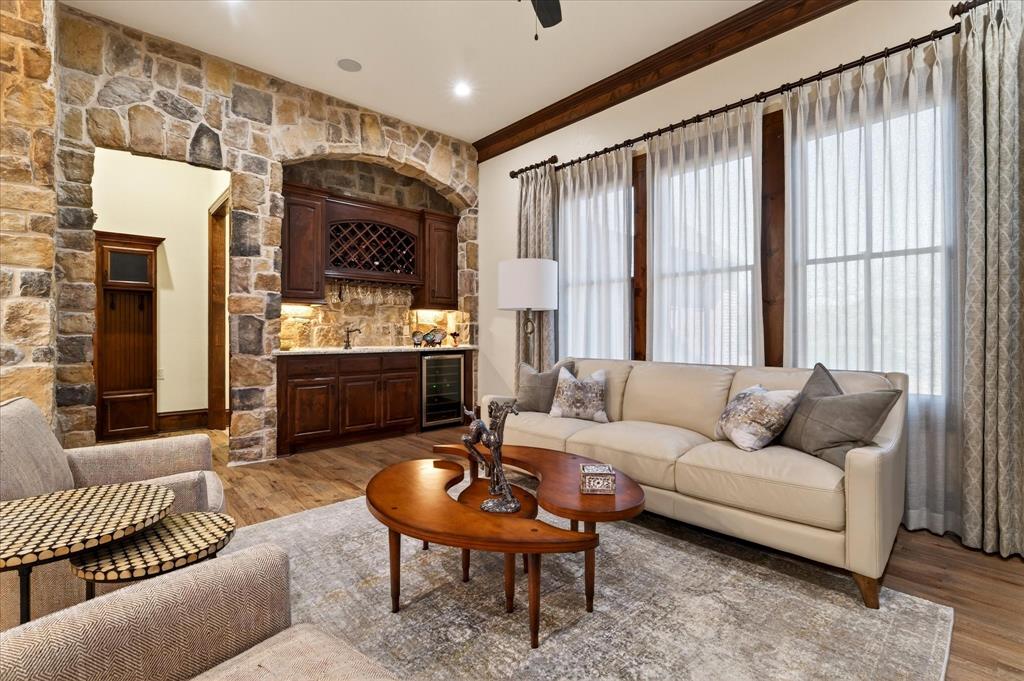 1625 Timber Ridge Trail Cross Roads, TX 76227 - Photo 26 of 40 Living room with wet bar, light wood finished floors, wine cooler, ceiling fan, and ornamental molding